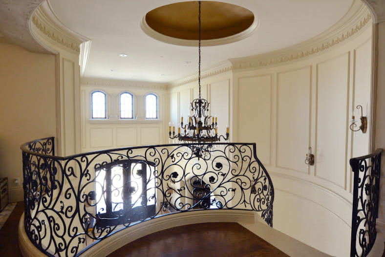 Example of a large tuscan curved metal railing staircase design in San Francisco with metal risers