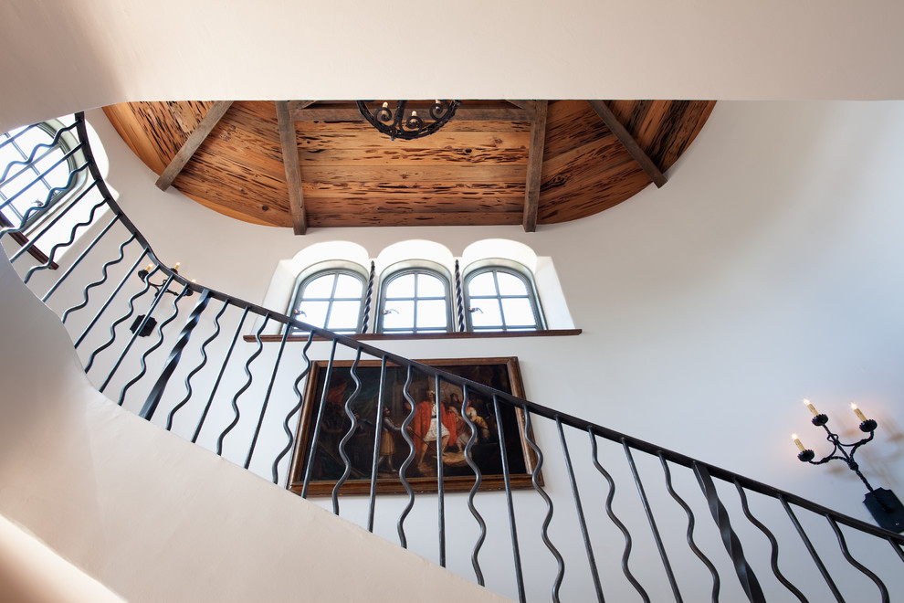 Example of a tuscan curved staircase design in Other