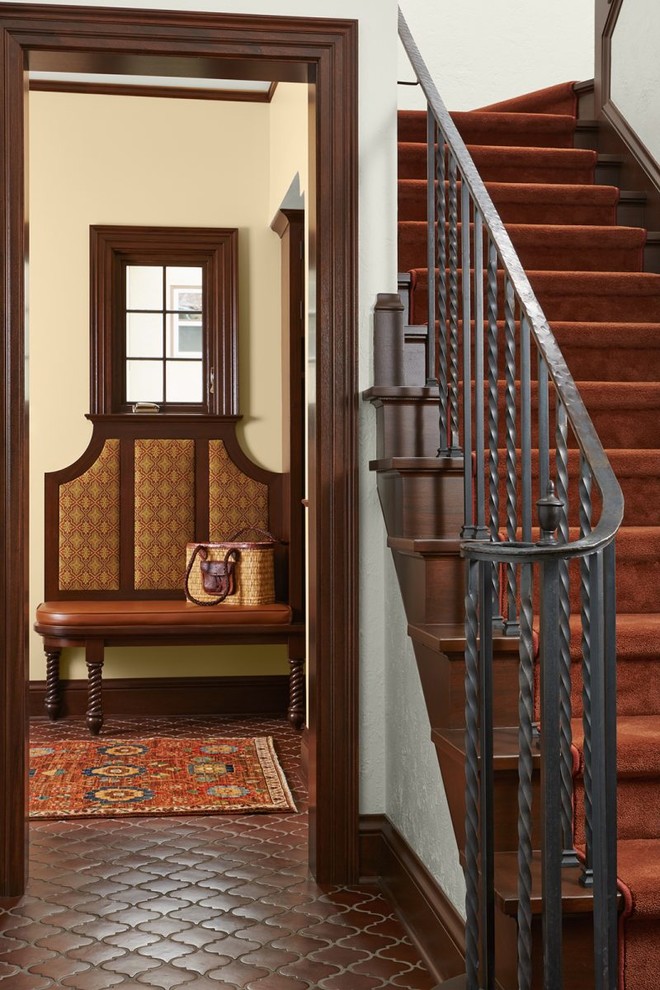 Staircase - mediterranean wooden curved metal railing staircase idea in Minneapolis with wooden risers