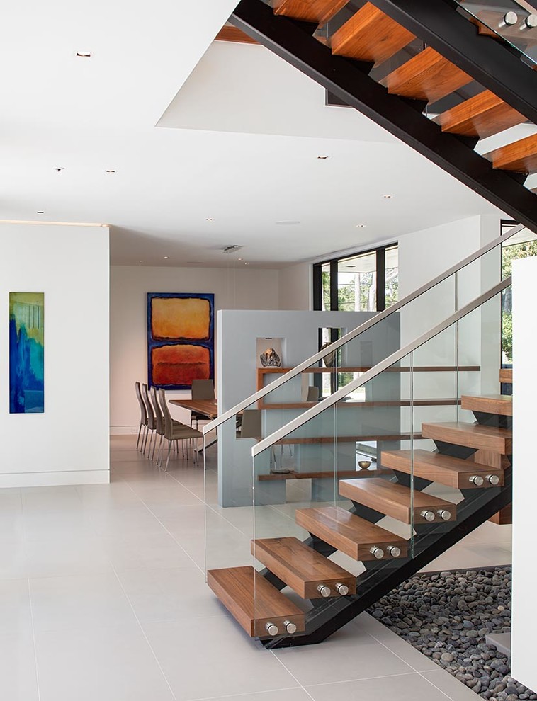 Example of a huge minimalist wooden u-shaped open staircase design in Houston