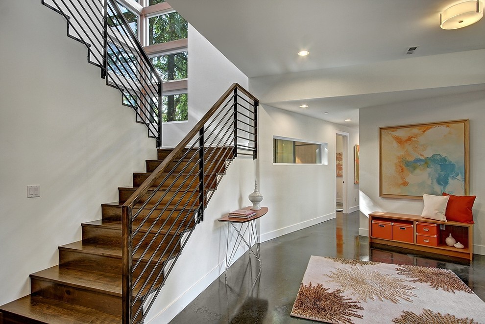 Imagen de escalera en L contemporánea con escalones de madera y contrahuellas de madera