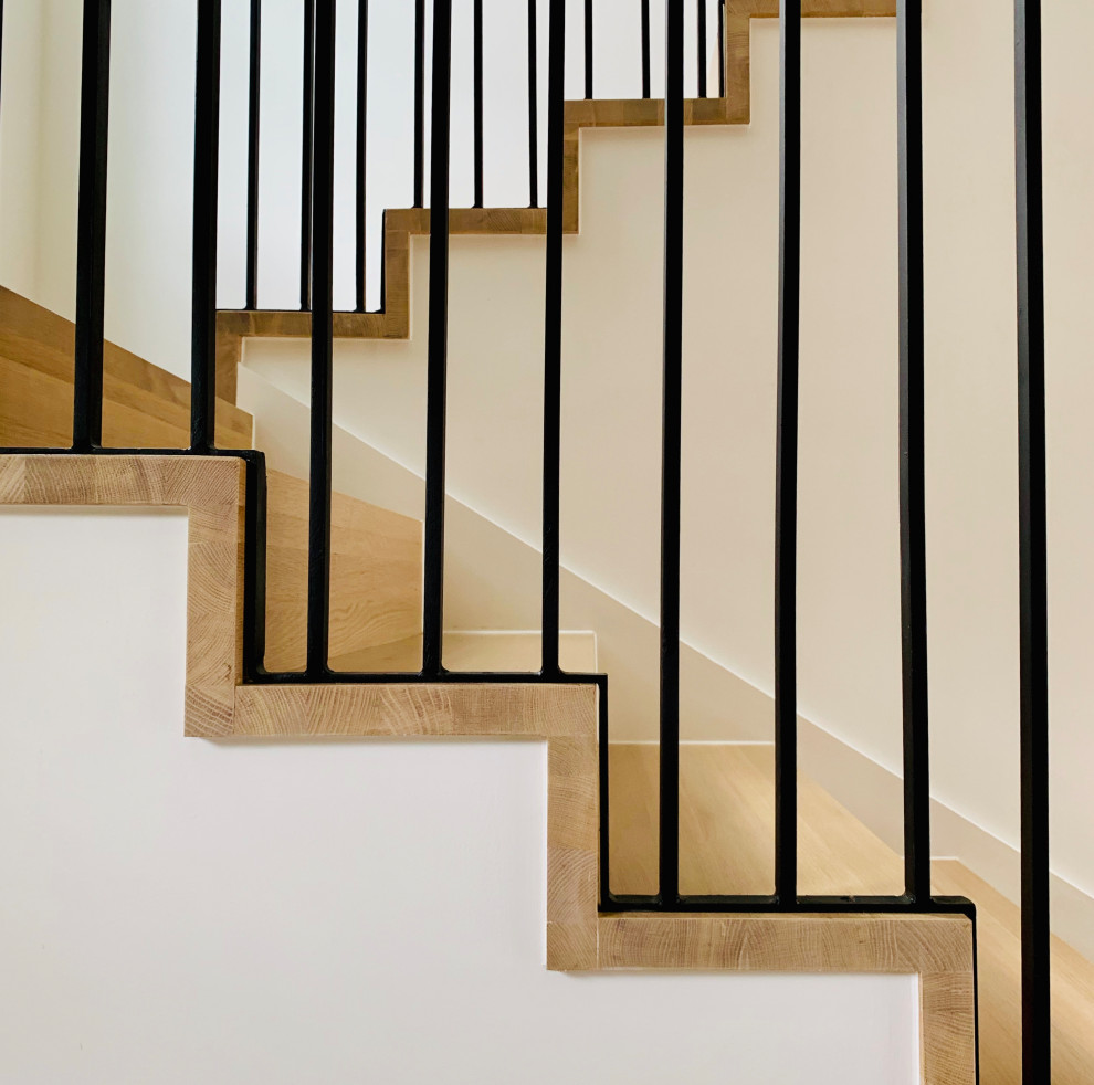 Photo of a scandi wood metal railing staircase in Austin with wood risers.