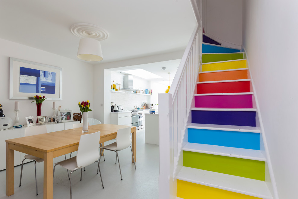 Trendy painted l-shaped staircase photo in London with painted risers