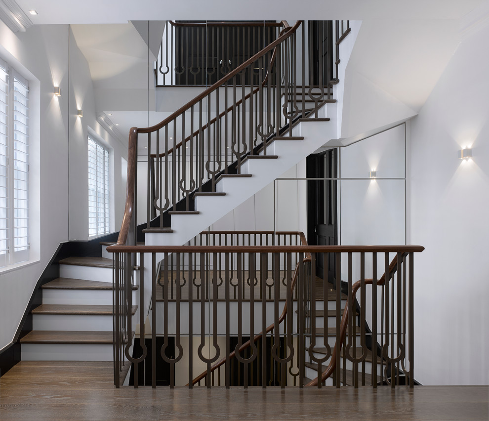 Design ideas for a medium sized classic wood curved staircase in London with painted wood risers.