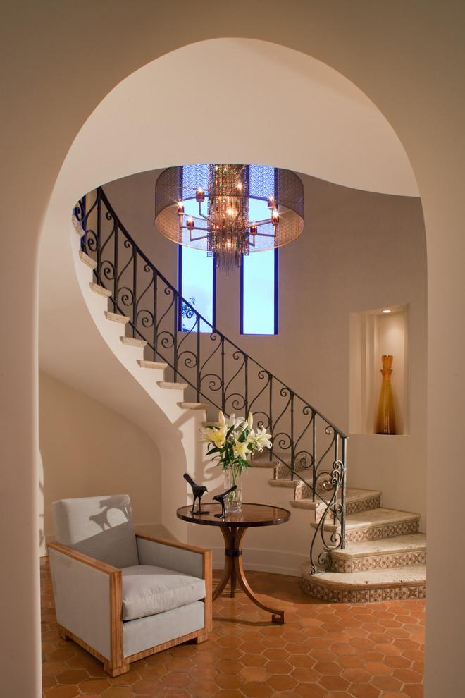 Photo of a mediterranean metal railing staircase in Miami with travertine treads.