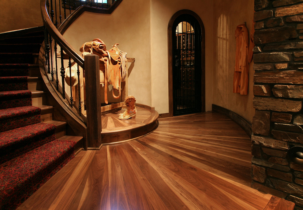 Imagen de escalera curva rústica extra grande con escalones de madera y contrahuellas enmoquetadas
