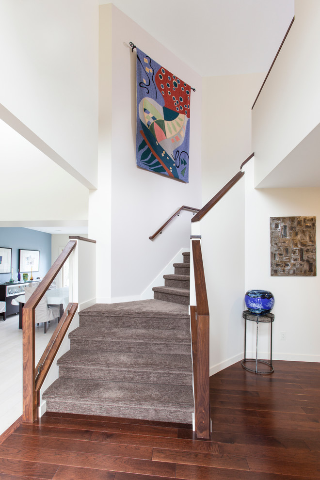 Inspiration for a contemporary carpeted l-shaped staircase in Detroit with carpeted risers.