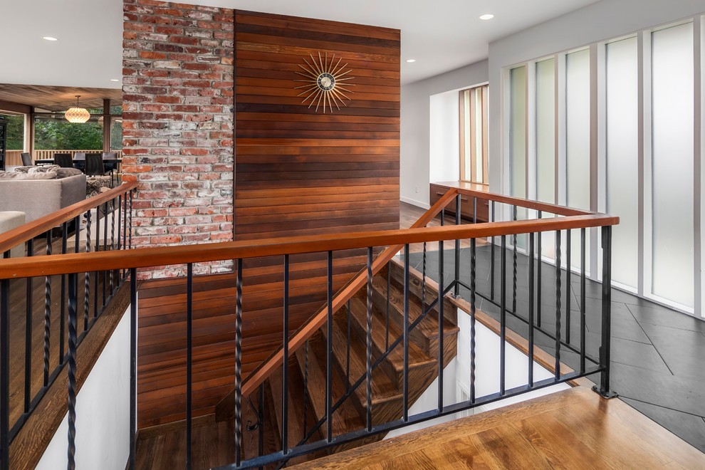Inspiration for a large midcentury wood u-shaped staircase in Seattle with wood risers.