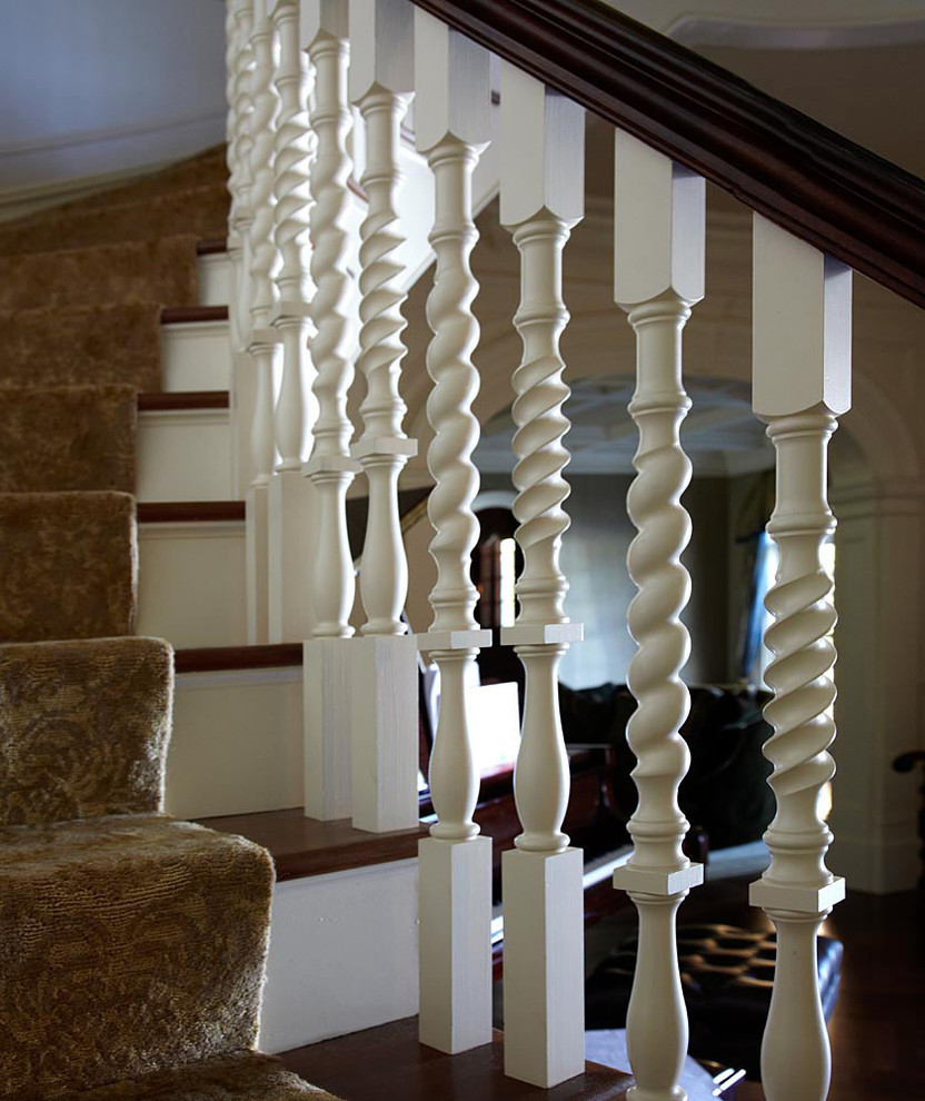 Photo of a traditional wood curved staircase in New York with painted wood risers.