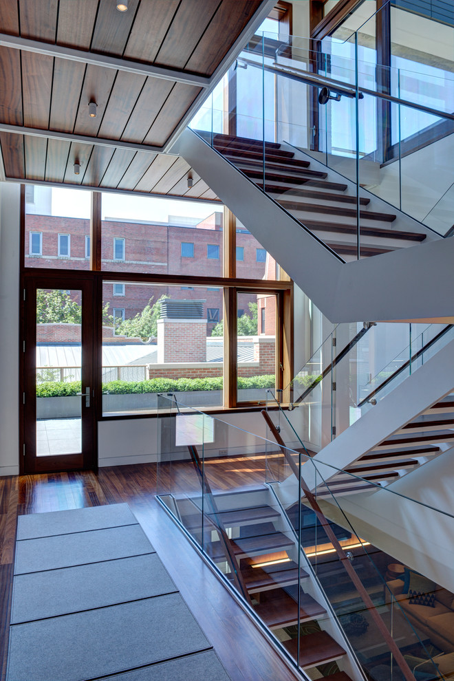 Inspiration for an industrial glass railing staircase in Chicago with open risers.