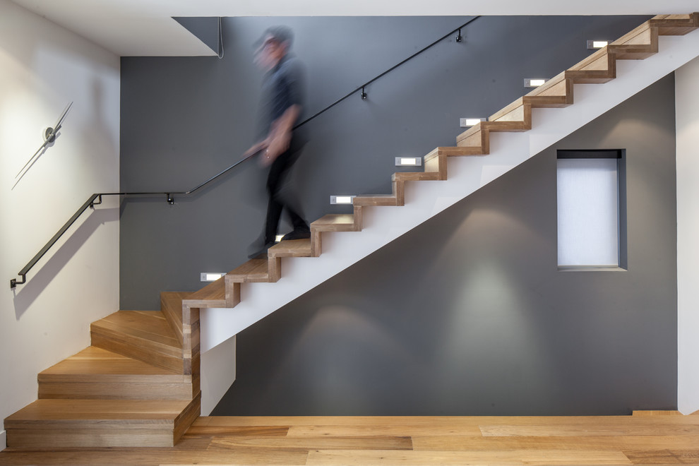 Inspiration for a contemporary wood l-shaped staircase in Toronto with wood risers.