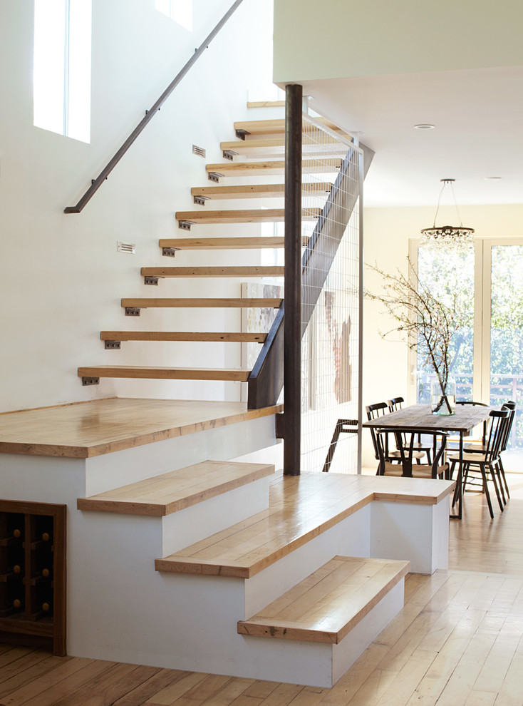 Inspiration for a large modern wooden l-shaped wood railing staircase remodel in San Francisco with wooden risers