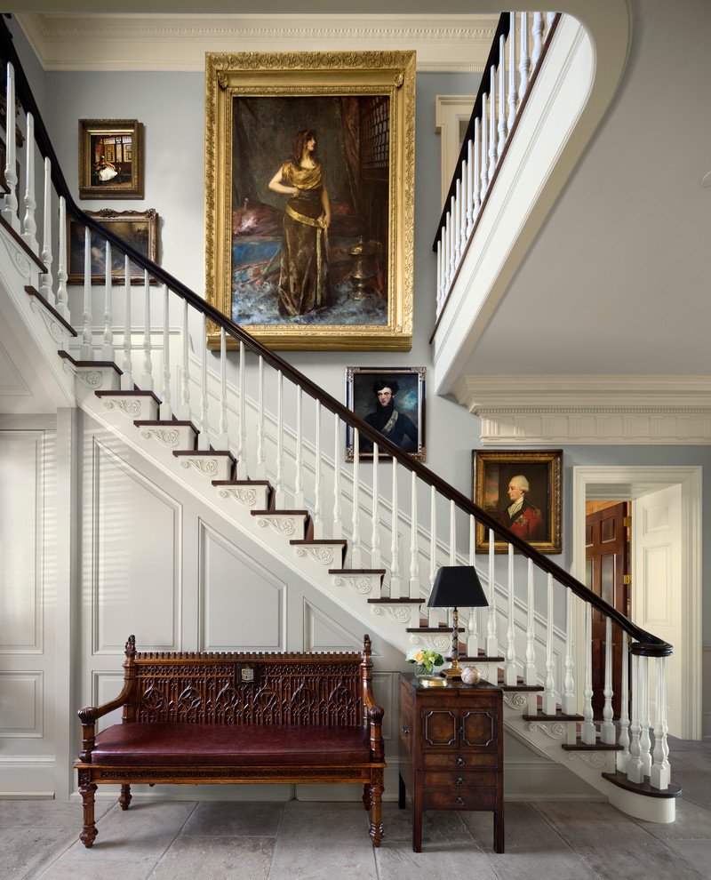 This is an example of a victorian wood l-shaped staircase in New York with painted wood risers and feature lighting.