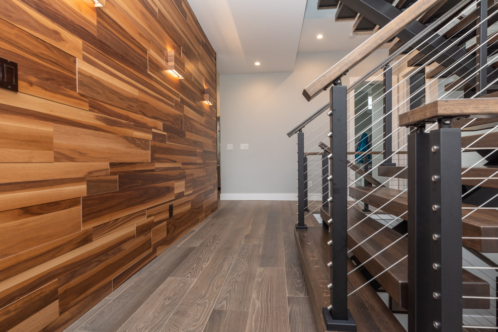 Inspiration for a medium sized modern wood u-shaped wire cable railing staircase in Minneapolis with open risers.