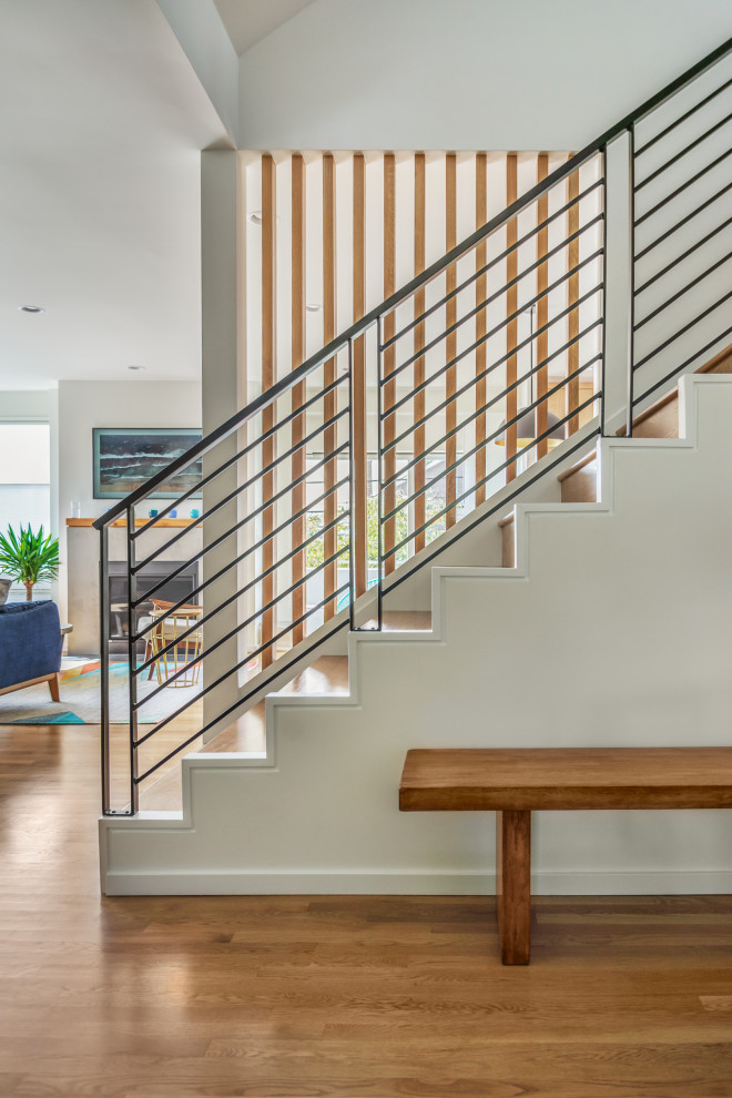Design ideas for a medium sized contemporary wood straight metal railing staircase in Seattle with wood risers.
