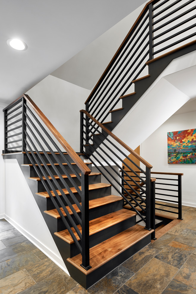 Photo of a medium sized nautical wood u-shaped mixed railing staircase in Minneapolis with metal risers and feature lighting.