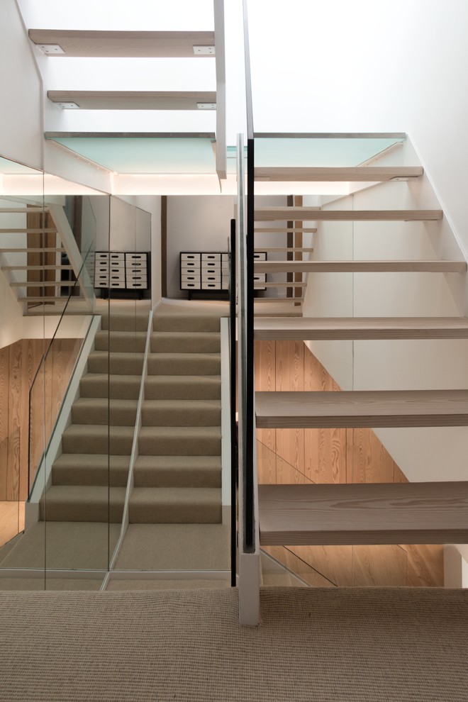 Inspiration for a medium sized contemporary wood straight staircase in London with open risers.