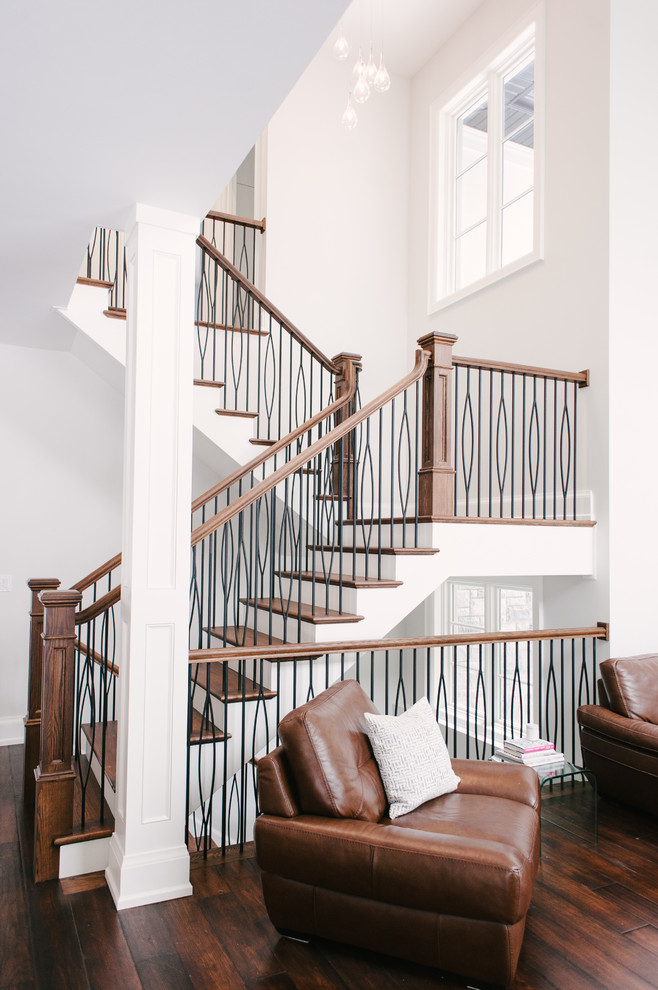 Photo of an expansive contemporary wood u-shaped mixed railing staircase in Toronto with wood risers.