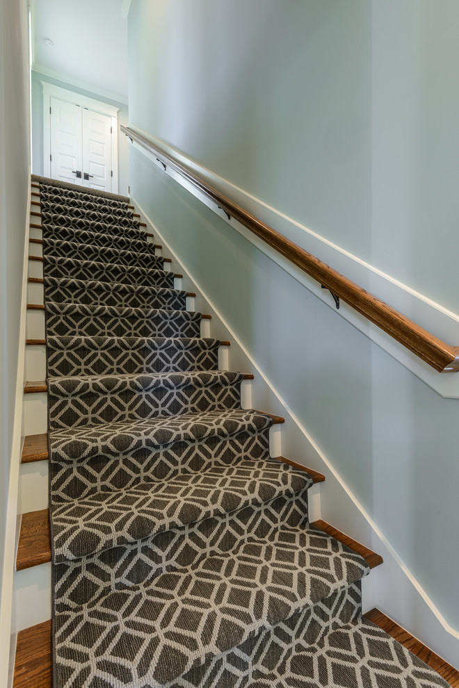 Example of a mid-sized transitional carpeted straight wood railing staircase design in Other with carpeted risers