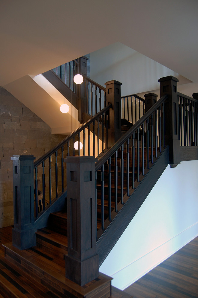 Example of a large arts and crafts wooden u-shaped wood railing staircase design in Vancouver with wooden risers