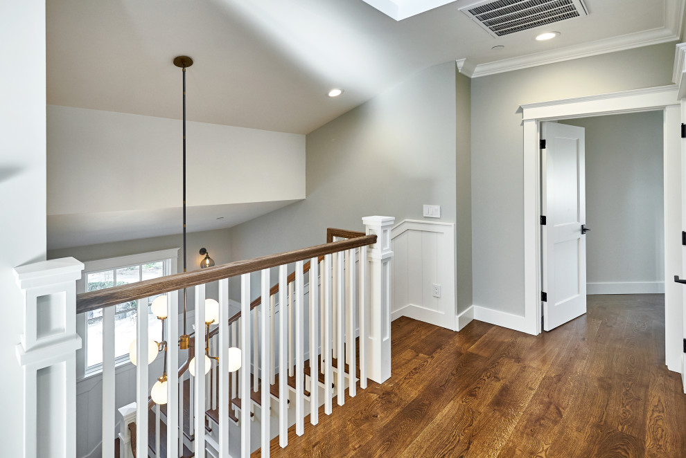 Example of a mid-sized arts and crafts wooden u-shaped wood railing staircase design in San Francisco with painted risers