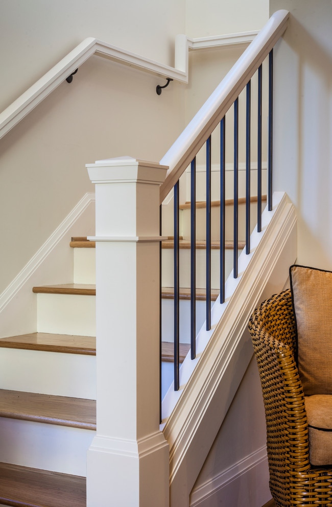 Small arts and crafts wooden l-shaped staircase photo in Portland with painted risers
