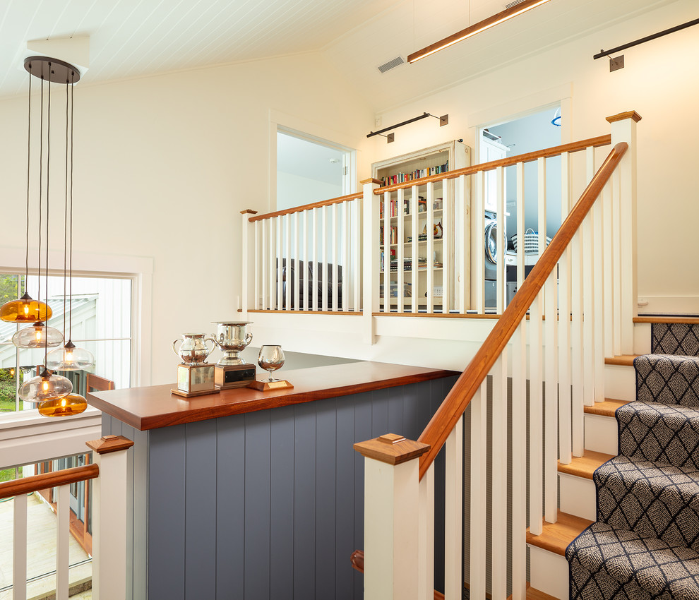 Design ideas for a medium sized nautical wood u-shaped wood railing staircase in Other with wood risers.