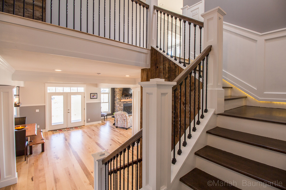 Staircase - rustic wooden curved staircase idea in Burlington with wooden risers