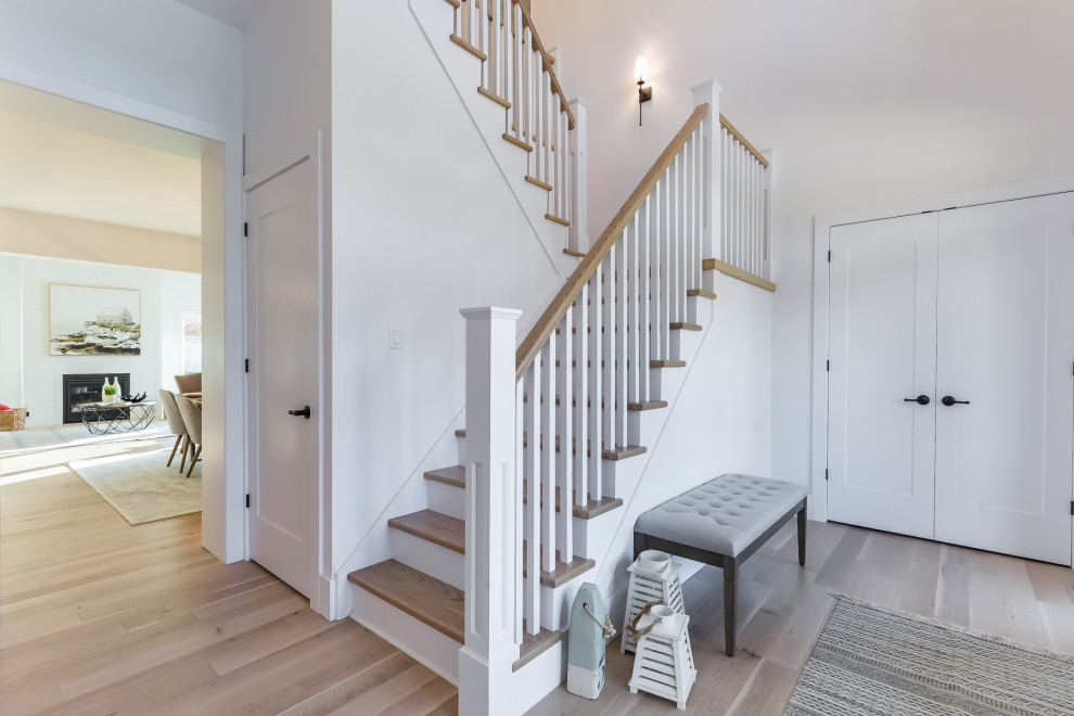Example of a large country wooden l-shaped wood railing staircase design in Toronto with wooden risers