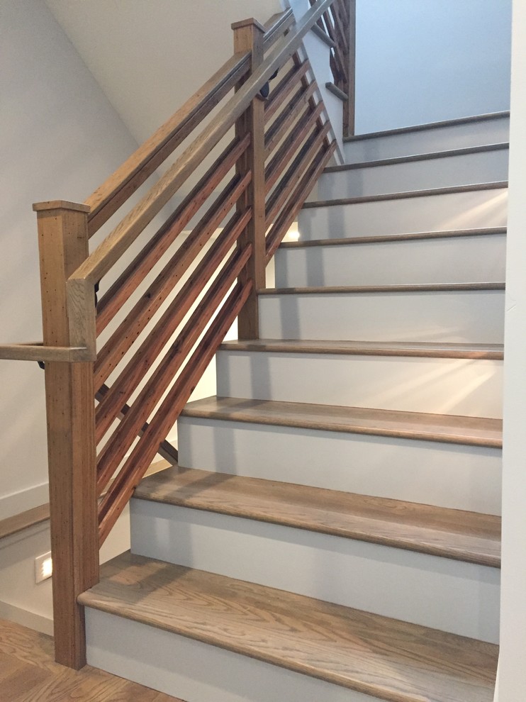 Modelo de escalera en U campestre de tamaño medio con escalones de madera, contrahuellas de madera pintada y barandilla de madera