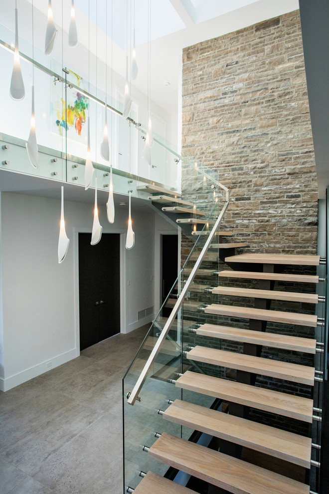 Contemporary wood l-shaped mixed railing staircase in Toronto with open risers.
