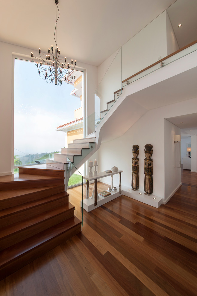 Inspiration for a contemporary wood u-shaped staircase in Other with wood risers.