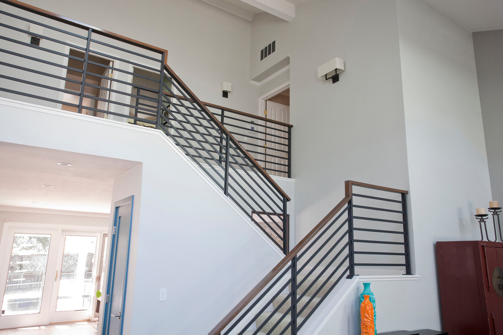 Inspiration for a large modern carpeted u-shaped metal railing staircase remodel in San Francisco with carpeted risers
