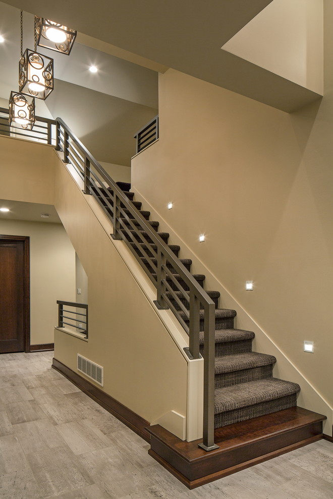 Large trendy carpeted straight staircase photo in Omaha with carpeted risers