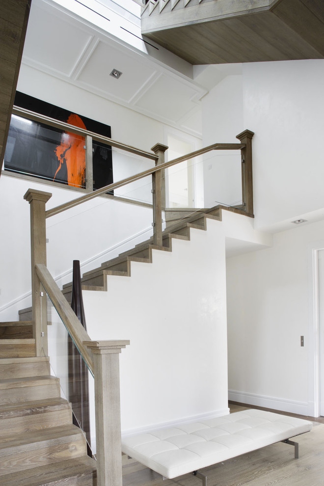 Contemporary wood staircase in Madrid with wood risers.