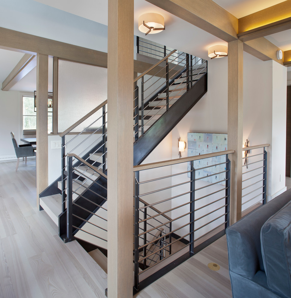 Large rustic wood floating staircase in Denver with open risers and feature lighting.
