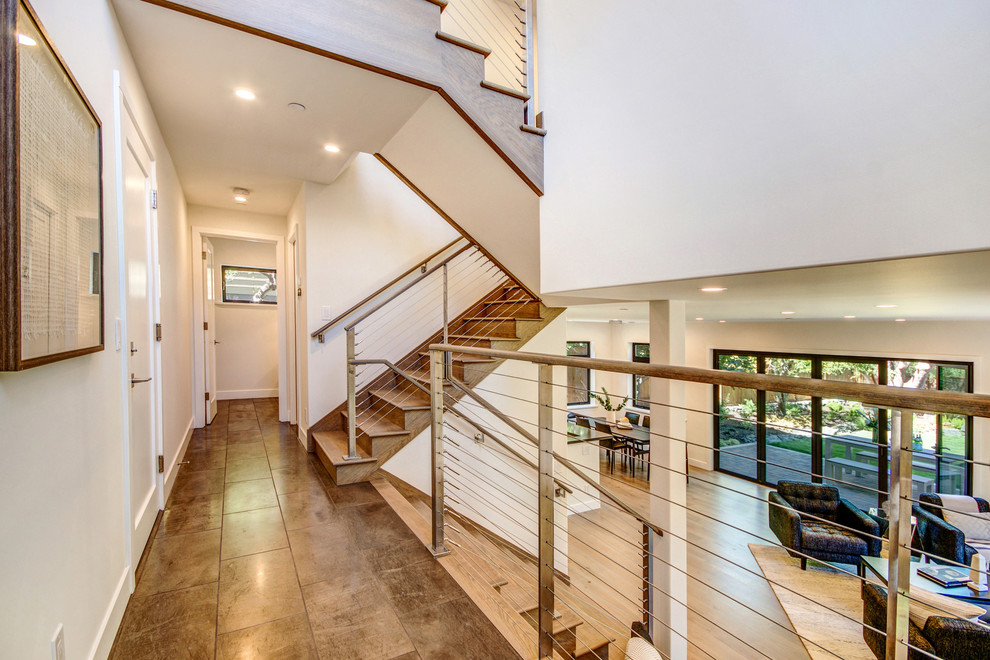 Large transitional wooden l-shaped staircase photo in San Francisco with wooden risers