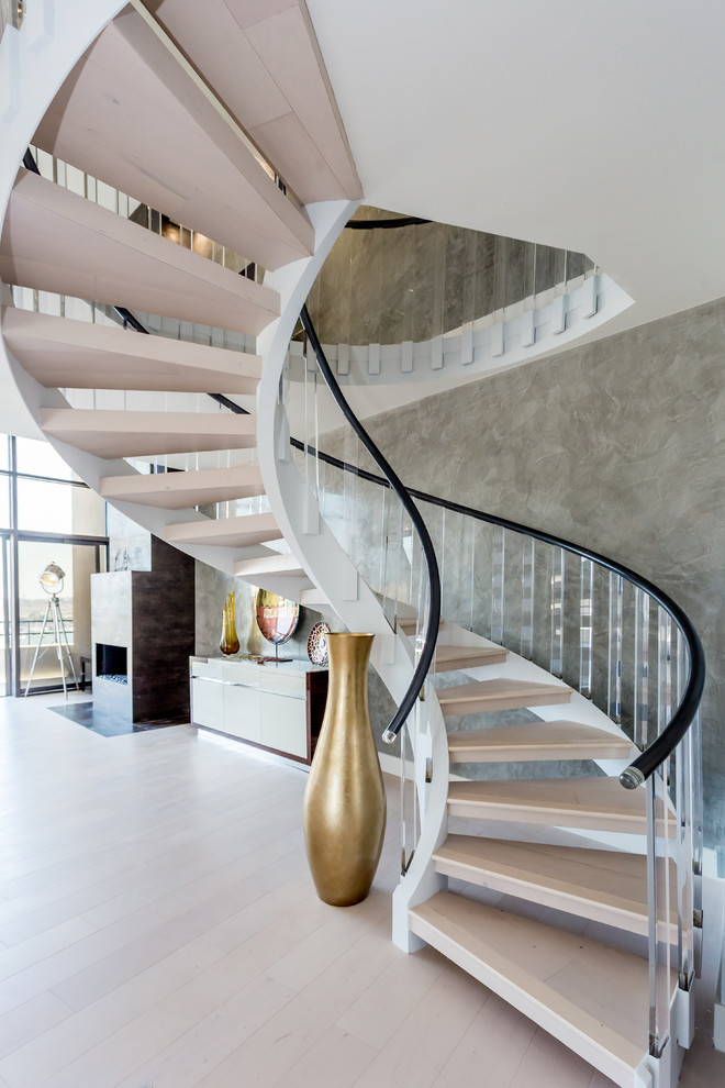 Trendy wooden curved open and mixed material railing staircase photo in Los Angeles