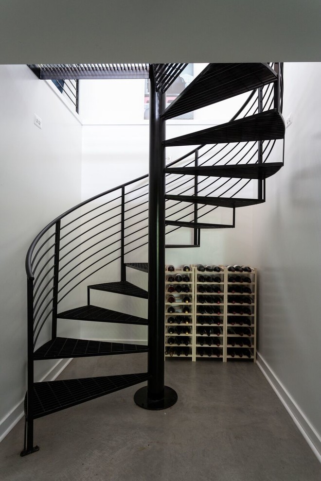 Design ideas for a medium sized modern metal spiral metal railing staircase in DC Metro with open risers.
