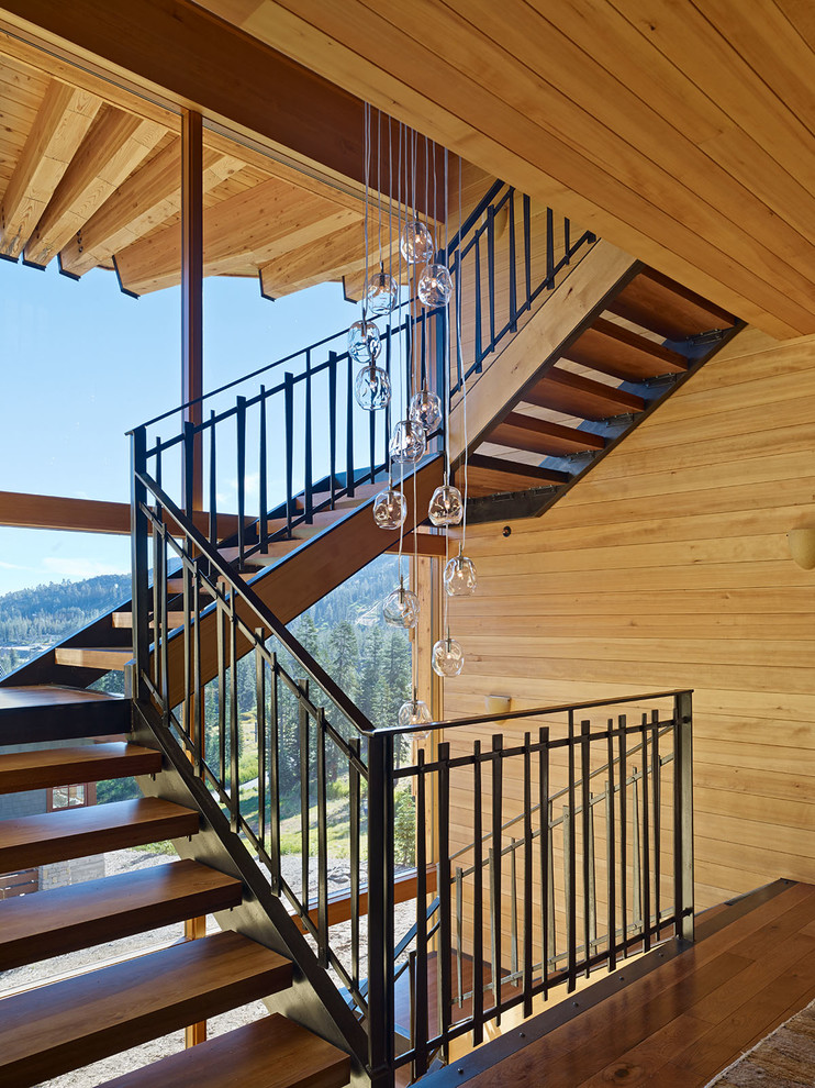 Huge mountain style wooden u-shaped open staircase photo in San Francisco