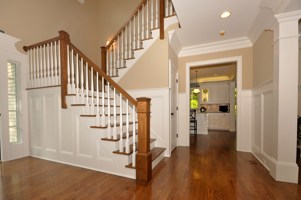 Стильный дизайн: п-образная лестница среднего размера в классическом стиле с деревянными ступенями, крашенными деревянными подступенками и деревянными перилами - последний тренд