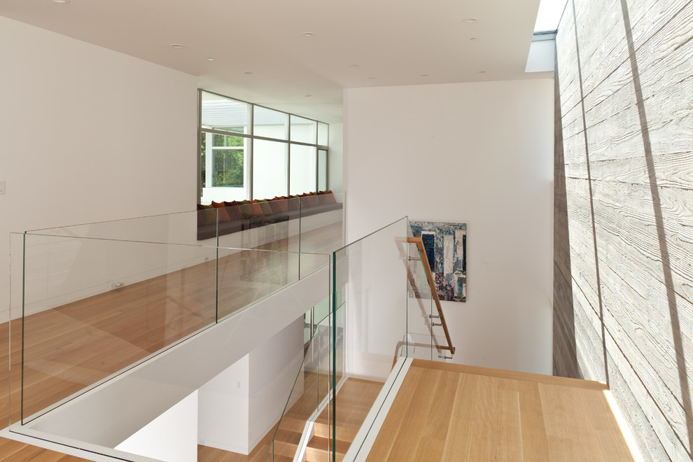 Источник вдохновения для домашнего уюта: п-образная деревянная лестница в стиле модернизм с деревянными ступенями и стеклянными перилами