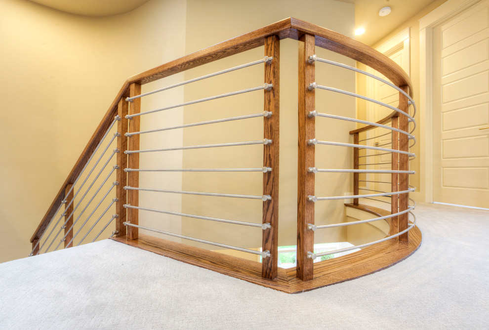 Medium sized modern carpeted curved staircase in Seattle with carpeted risers and feature lighting.