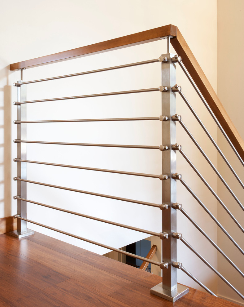 Medium sized modern wood straight staircase in Seattle with wood risers.