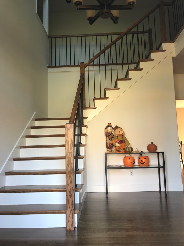 Example of a large mid-century modern wooden l-shaped wood railing staircase design in Portland with painted risers