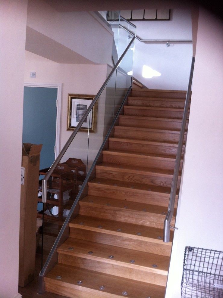 Inspiration for a contemporary wood straight staircase in Devon with open risers.