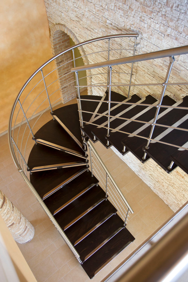 Inspiration for a modern wooden curved open staircase remodel in San Francisco