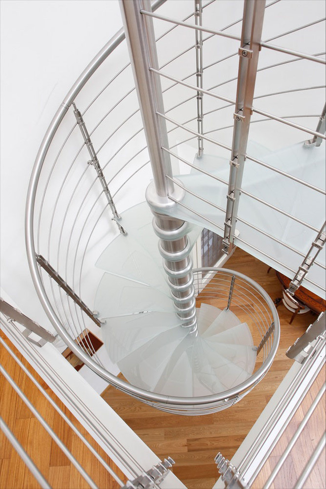 Modern glass spiral staircase in San Francisco with open risers.