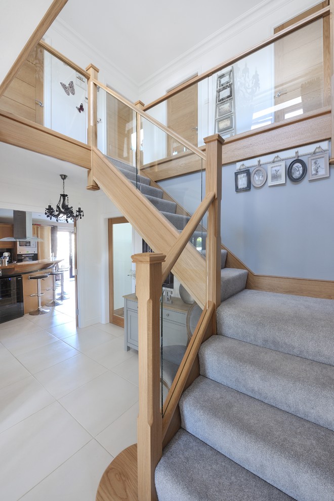 Example of a mid-sized trendy carpeted l-shaped wood railing staircase design in Other with wooden risers