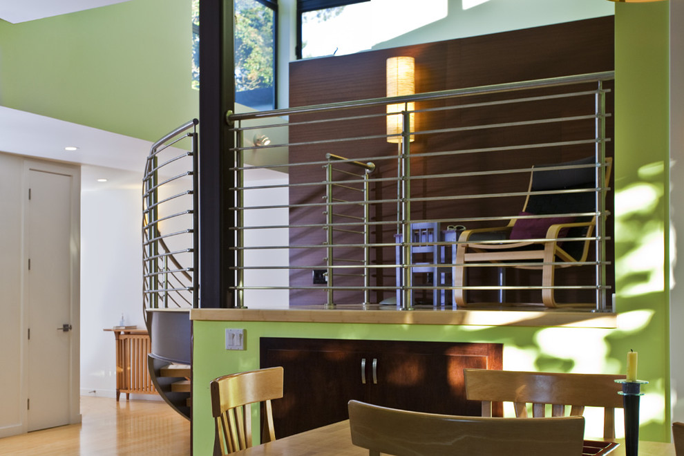 Design ideas for a medium sized modern wood curved metal railing staircase in San Francisco with open risers.